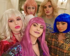 four women in wigs posing for the camera