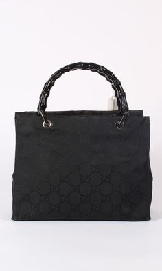 OR 4 interest-free installments of $212.50 USD by Vintage monogram Gucci small tote bag. Black canvas with tonal interlocking GG logo throughout. Chrome hardware. Two interior compartments. Two inner zip pockets. Black bamboo handles. Bag Dimensions (inches): 12 W x 9 H x 4.5 D. Handles: 4.5" tall Condition: Good. Some scuffing on handles.. Modern Gucci Bag, Modern Black Shoulder Bag With Bamboo Handle, Black Bags With Bamboo Handle And Double Handle, Black Bags With Bamboo Double Handle, Black Bag With Bamboo Handle For Shopping, Black Shopping Bags With Bamboo Handle, Black Bags With Bamboo And Double Handle, Classic Gucci Coated Canvas Bag, Gucci Bamboo Handle Rectangular Bag