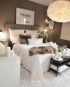 a bedroom with white bedding and fluffy pillows