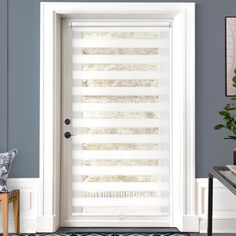 a white door with vertical blinds on the side and an area rug in front of it