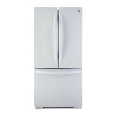 a white refrigerator freezer sitting on top of a white counter next to a wall