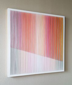 an abstract painting on the wall with vertical lines in red, orange and pink colors