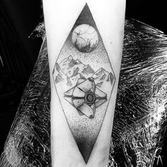 a black and white photo of a tattoo on the arm