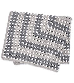 two gray and white crocheted dishcloths sitting on top of each other