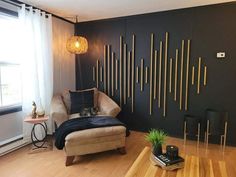 a living room with wood floors and black walls