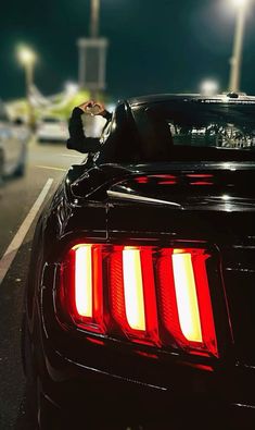 the tail lights of a black sports car