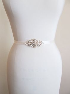 "This elegant bridal belt is made with Swarovski crystals beaded on 5/8\" wide double face satin ribbon. The crystal part of the belt measures 3 1/2\" long and 1 5/8\" wide in the center. The entire sash measures 150\" long. Available in gold, silver or rose gold finish. * Shown in gold finish with antique white ribbon" Bridal Belts And Sashes, Wedding Belts And Sashes, Bridal Sash Belt, Wedding Belt, Crystal Bridal Earrings, Crystal Belt, Wedding Sash Belt, Wedding Sash, Bridal Stores