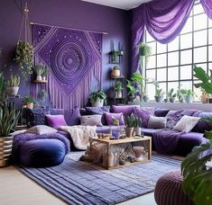 a living room with purple walls and plants