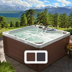 an outdoor hot tub with mountains in the background