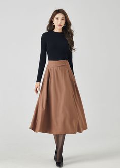 "Discover our classic brown wool A-line skirt, a timeless addition to your winter wardrobe. The rich brown color exudes sophistication, while the premium wool fabric ensures warmth and comfort. This versatile A-line skirt is perfect for both work and casual outings, making it a must-have choice for staying chic and cozy. DETAILS * 30% wool blend, 40% fiber and polyester, 40% nylon * Full polyester lining * Without pocket * Back zipper closure * Vintage inspired skirt * Suitable for autumn and winter  * Mid calf length * Dry clean MODEL SIZE Bust 85 cm(33.4\") Waist 67 cm(26.7\") Height 168cm (5' 6\") She wears size XS Choose CUSTOM Order if you * Need other color * Can't find your size in our size Chart * Chang the Length * Your Height is not Between 5'1\" - 5\"9\" * Your weight is not fro Formal Flared Skirt For Fall, Flared Skirt For Formal Fall Occasions, Beige A-line Pleated Skirt For Fall, Classic A-line Pleated Skirt For Fall, Elegant A-line Fall Skirt, Winter Workwear Lined Maxi Skirt, Winter Workwear Maxi Skirt With Lining, Lined Maxi Skirt For Winter Workwear, Formal Midi Skirt For Fall