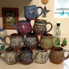 a stack of coffee mugs sitting on top of a counter