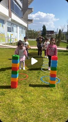 children playing with giant blocks in the grass