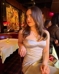 a woman sitting at a table in a restaurant