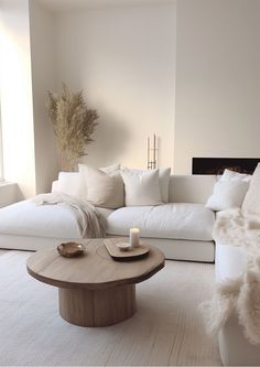 a living room filled with white furniture and pillows