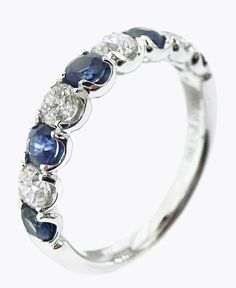 a white gold ring with blue and clear stones