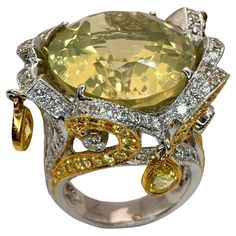 Indulge in luxury with our 18k Diamond and Yellow Sapphire Cocktail Ring. Crafted with 1.54 carats of sparkling diamonds and a stunning 2.93 carat yellow sapphire center, this ring exudes elegance and sophistication. Made with 18k white and yellow gold, weighing 16.4 grams and marked with "750", it is a testament to impeccable craftsmanship. In excellent condition with minor surface wear, this ring is a statement piece for any occasion. Available in size 6.75. 18k Diamond and Yellow Sapphire Coc Rings Multiple, Floral Snake, Dragonfly Ring, Flower Diamond Ring, Contemporary Fine Jewelry, Sapphire Cocktail Ring, Obsidian Ring, Vintage Cocktail Ring, Tsavorite Garnet