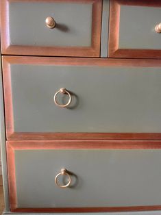 the drawers are painted gray and have gold handles