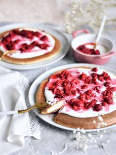 two desserts with strawberries and whipped cream on them are ready to be eaten