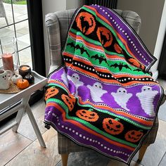 a chair with a halloween themed blanket on it