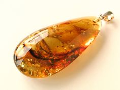 "Natural Baltic amber green color pendant shaped in drop form goes perfectly with every outfit! Perfect choice to brighten up office outfit or look even more beautiful on a special occassion! MATERIALS AND SIZE: Stone: 100% Natural Baltic Amber Other materials: silver 925 Weight: 11,6 g (0,4 oz) Bead size: 5,5 cm (2,16 in) x 2,6 cm (1,02 in) x 1,5 cm (0,59 in) PLEASE NOTE: All our amber production is made of natural amber. Amber is an unique stone and every piece is handmade, therefore there mig Unique Amber Teardrop Jewelry, Amber Teardrop Necklace For Jewelry Making, Amber Teardrop Necklaces For Jewelry Making, Unique Teardrop Amber Jewelry, Teardrop Baltic Amber Necklace In Amber Color, Teardrop Baltic Amber Necklace, Handmade Baltic Amber Teardrop Jewelry, Amber Pear-shaped Jewelry Gift, Amber Drop Jewelry For Jewelry Making