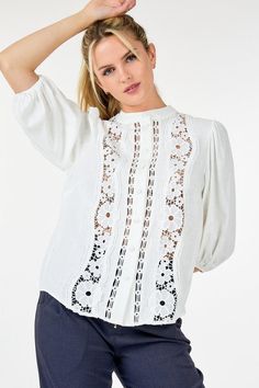 Indulge in the feminine elegance of our Women's 3/4 Lace Crochet Button Down Blouse. Crafted with delicate lace crochet, this top exudes sophistication and grace. The button-down design adds a touch of classic charm. Elevate your wardrobe with this exclusive and timeless piece. This top boasts delicate lace detailing that exudes femininity and refinement while its 3/4 sleeves strike a balance between coverage and freedom of movement. The collarless design lends a modern touch.Additionally the long popcorn sleeves add texture and visual interest elevating the tops overall appeal. - Solid - Round neckline I Collarless - Lace detailing - 3/4 Sleeve I Popcorn Feminine Crochet Lace Top For Spring, Elegant White Crochet Top With Lace Sleeves, White Crochet Top With Lace Collar, Spring Chic Crochet Lace Top, Spring Lace Blouse With 3/4 Sleeves, Feminine Lace Trim Crochet Top, Feminine Crochet Top With Lace Trim, Spring Feminine Lace Collar Top, Lace Blouse With 3/4 Sleeves For Spring