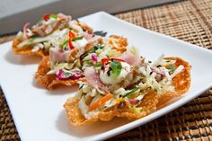 two appetizers are sitting on a white plate