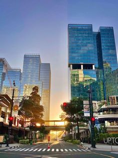 an intersection with traffic lights and skyscrapers in the background