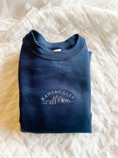 The cozy accessory your closet has been missing 🏙 This is a made to order item. Please allow 1-2 weeks before item is shipped.  Embroidered crewneck sweatshirt. 50% preshrunk cotton, 50 % polyester. Unisex fit. Design size is approximately 2x4 inches Blue Crew Neck Sweatshirt With Embroidered Logo, Navy Crew Neck Sweater With Embroidered Logo, Navy Cotton Sweatshirt With Embroidered Logo, Cotton Crew Neck Sweatshirt With Embroidered Graphics, Blue Crew Sweatshirt With Embroidered Graphics, Custom Embroidered Crew Neck Sweatshirt In Relaxed Fit, Custom Embroidery Relaxed Fit Crew Neck Sweatshirt, Relaxed Fit Sweatshirt With Custom Embroidery And Crew Neck, Relaxed Fit Crew Neck Sweatshirt With Custom Embroidery