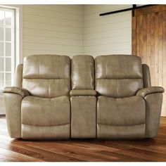 the reclining loveseat has two seats and is in front of a wooden floor