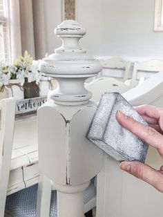 a person cleaning a white table with a sponge