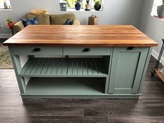 a kitchen island with wooden top in a living room