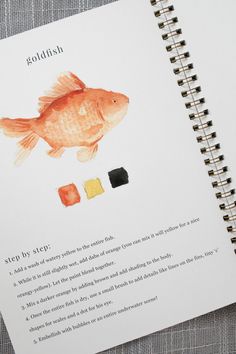 a book with an image of a goldfish on it's cover and instructions for how to paint