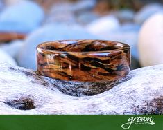 a wooden ring sitting on top of a rock