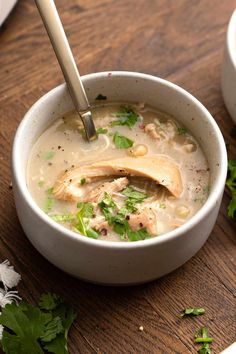 a white bowl filled with soup on top of a wooden table