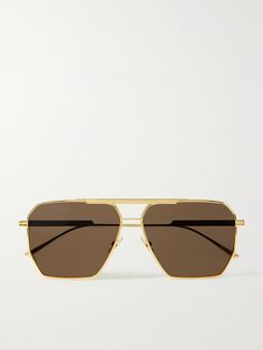 Find BOTTEGA VENETA Original Aviator-style -tone Sunglasses on Editorialist. Bottega Veneta Eyewear puts a fresh spin on so many classics and has managed to make aviator-style sunglasses even cooler with its octagon-shaped frames. This 'Original' gold-tone pair houses brown lenses with adjustable nose pads for a comfortable fit. The acetate-tipped arms are designed with the brand's signature double bars and discreetly engraved with a logo. Bottega Sunglasses, Brown Sunglasses Women, Octagon Sunglasses, Fancy Glasses, Black Aviator Sunglasses, Big Sunglasses, Gold Glasses, Gold Aviator Sunglasses, Sunglasses Women Aviators