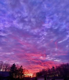 the sky is purple and pink with clouds