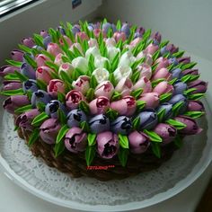 there is a cake decorated with flowers on the table