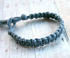 a close up of a bracelet on a wooden surface