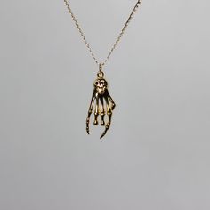 Rock on skeleton hand with skull 18k gold filled charm Pendant size 13mm x 30mm Now on new 18k stainless steel heavy gold plated chain *Gold-filled jewelry is jewelry composed of a solid layer of gold (typically constituting at least 5% of the item's total weight) mechanically bonded to a base alloy). Which means like solid gold, this piece is tarnish resistant, fade resistant and water resistant. The stainless steel chain has a thick gold plated layer that will keep your neck from turning green Gold Skull Necklace For Halloween, Halloween Skull Shaped Gold Jewelry, Nickel-free Gold Necklace For Halloween, Rock On Skeleton Hand, Rock On Skeleton, Skeleton Hand, Skeleton Hands, Rock On, Chain Gold