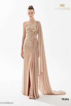 Looking for a show-stopping dress for your next special occasion? Check out the Tarik Ediz 98304 Creppe Spring 2023 evening collection dress. This gorgeous gown features a ruched bodice and flared skirt that is sure to make you feel like a princess. With its shimmering fabric and delicate details, this dress is sure to turn heads when you walk into the room. Whether you're attending a wedding, prom, or another formal event, this dress will have you looking your best. Order yours today and be rea Tarik Ediz Dresses, Gaun Fashion, Exquisite Gowns, Look Formal, Tarik Ediz, One Shoulder Gown, Chiffon Fashion, Beaded Bodice, فستان سهرة