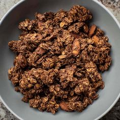 a bowl filled with granola sitting on top of a table