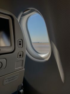 an airplane window looking out at the sky