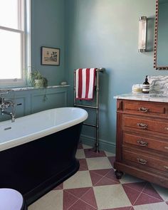 a bathroom with a checkered floor and blue walls