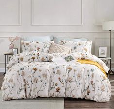 the comforter is made up with flowers on it