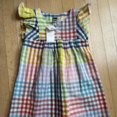 Adorable And Colorful Woven Dress Multicolor Flutter Sleeve Dress For Playtime, Cute Multicolor Flutter Sleeve Dress, Plaid Cotton Dress For Playtime, Multicolor Cotton Dress For Playtime, Casual Multicolor Dress For Playtime, Casual Multicolor Dress For Play, Yellow Flutter Sleeve Beach Dress, Yellow Summer Play Dress, Yellow Summer Dress For Play