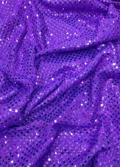 purple sequin fabric with small dots on it