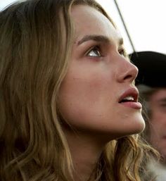 a close up of a person wearing a baseball cap and looking off into the distance