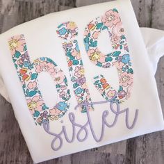 This is the perfect personalized shirt for your newly Big Sister! It comes on a high quality, white, cotton ruffle short or long sleeve shirt. When you are selecting the size of the shirt for your child, please keep in mind that it is 100% cotton, and it will shrink a little. The applique is backed with a soft backing to provide protection for sensitive skin from the stitches. Care instructions-   turn the item inside out and wash on a cool setting and hang to dry. Iron on low heat inside out. D Hand Embroidery Letters, Big Sister Little Sister, Sibling Shirts, Sister Shirt, Embroidery Letters, Big Sister Shirt, Sister Shirts, Oct 1, Big Sister