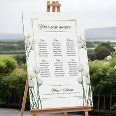 an easel with a seating chart on it