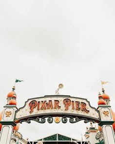 a sign that says pizzar pier in front of a building with an orange roof